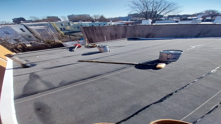 NYC waterproofing roof using black tar coating